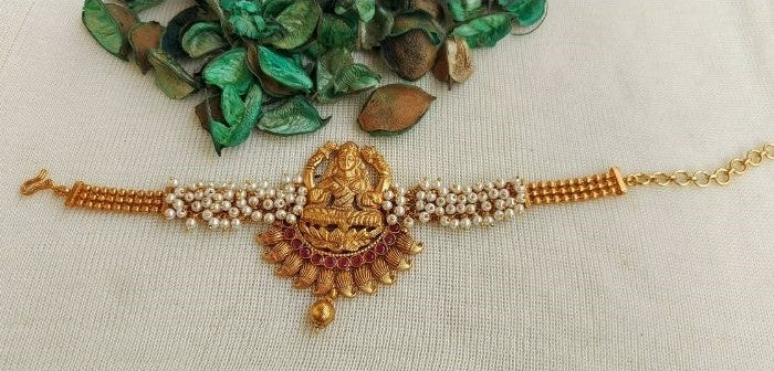 Ornate Laxmi Temple Waaki/Bajuband Featuring Gold-Toned Goddess Pendant and Pearl Detailing