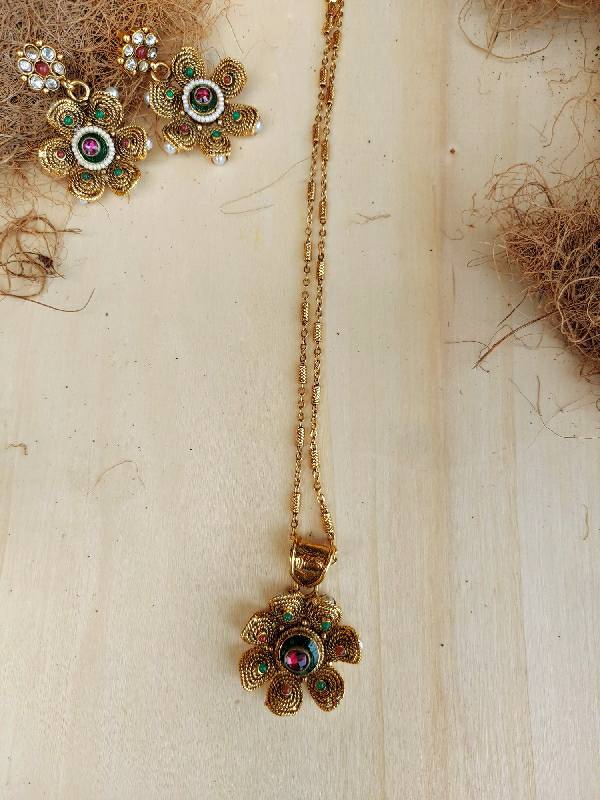 Multicolour Flower Pendant Necklace Set with Gold Chain on Wooden Surface