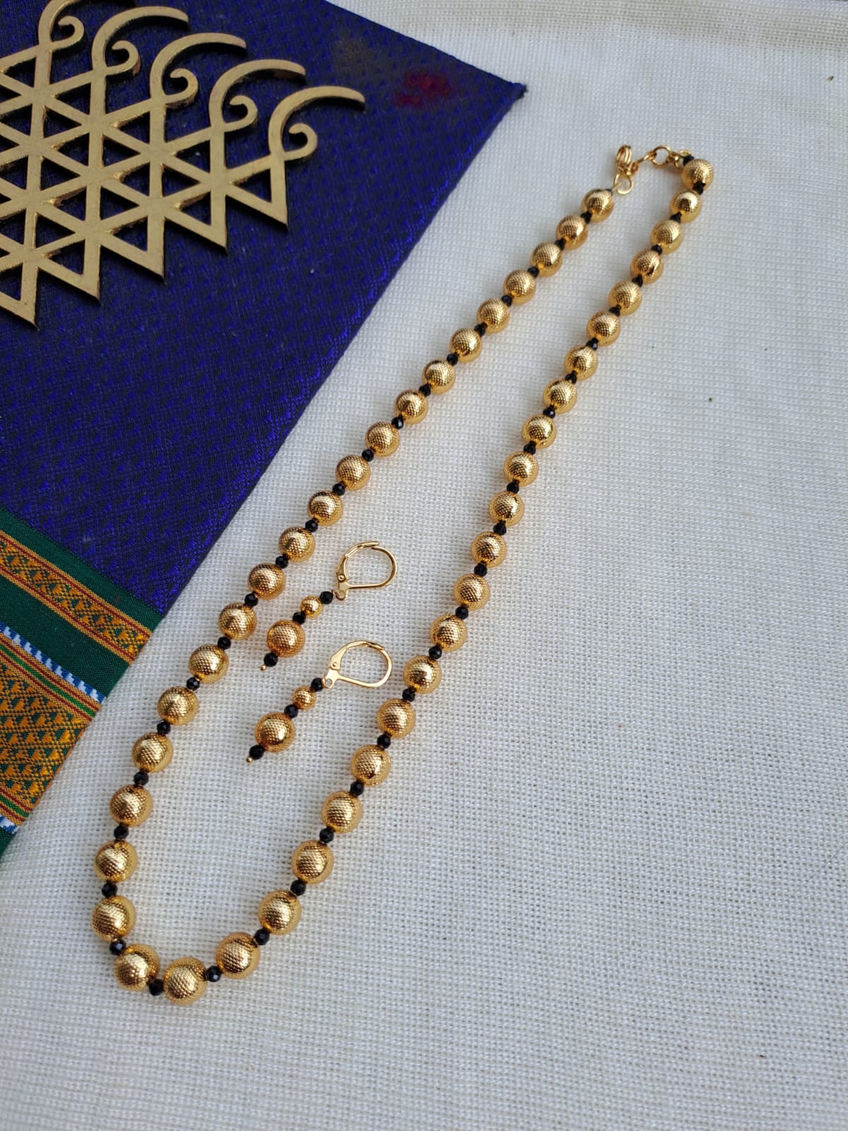Elegant Gold Bead Necklace with Black Crystal Accents
