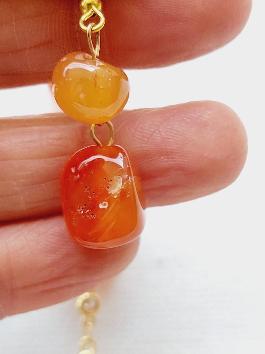 Vibrant orange glass beads with shimmering American diamond accents, showcased in a striking pendant design.