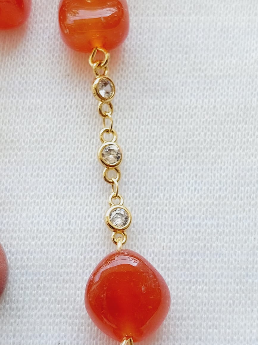 Orange Glass Beads American Diamond Set - Captivating gold-toned necklace with orange glass beads and sparkling diamond accents, showcased against a white background.
