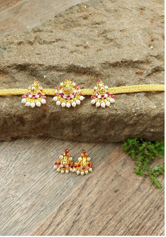 Elegant Set of Gold and Red Gemstone Peacock Bajuband and Choker on Natural Wooden Background