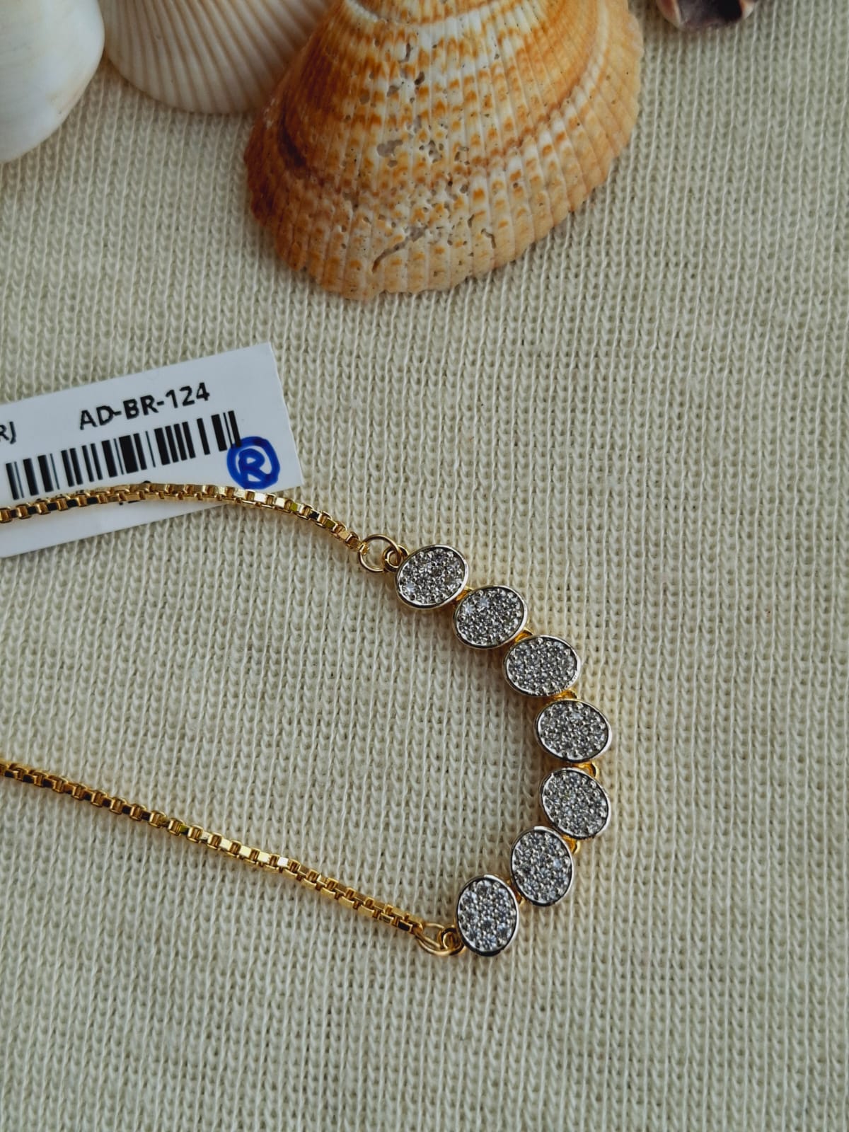 Beautiful Round Adjustable Bracelet from Mugdha Jewellery Store featuring a delicate gold-toned chain with a row of sparkling crystal-encrusted discs.