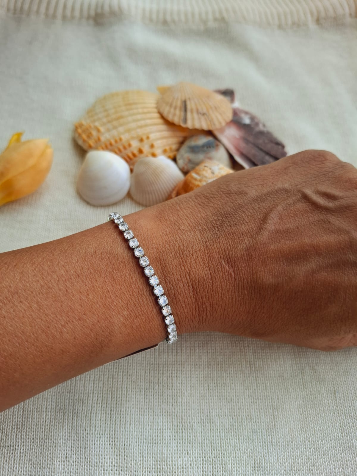 Elegant American Diamond Silver Adjustable Bracelet on Beige Seashells