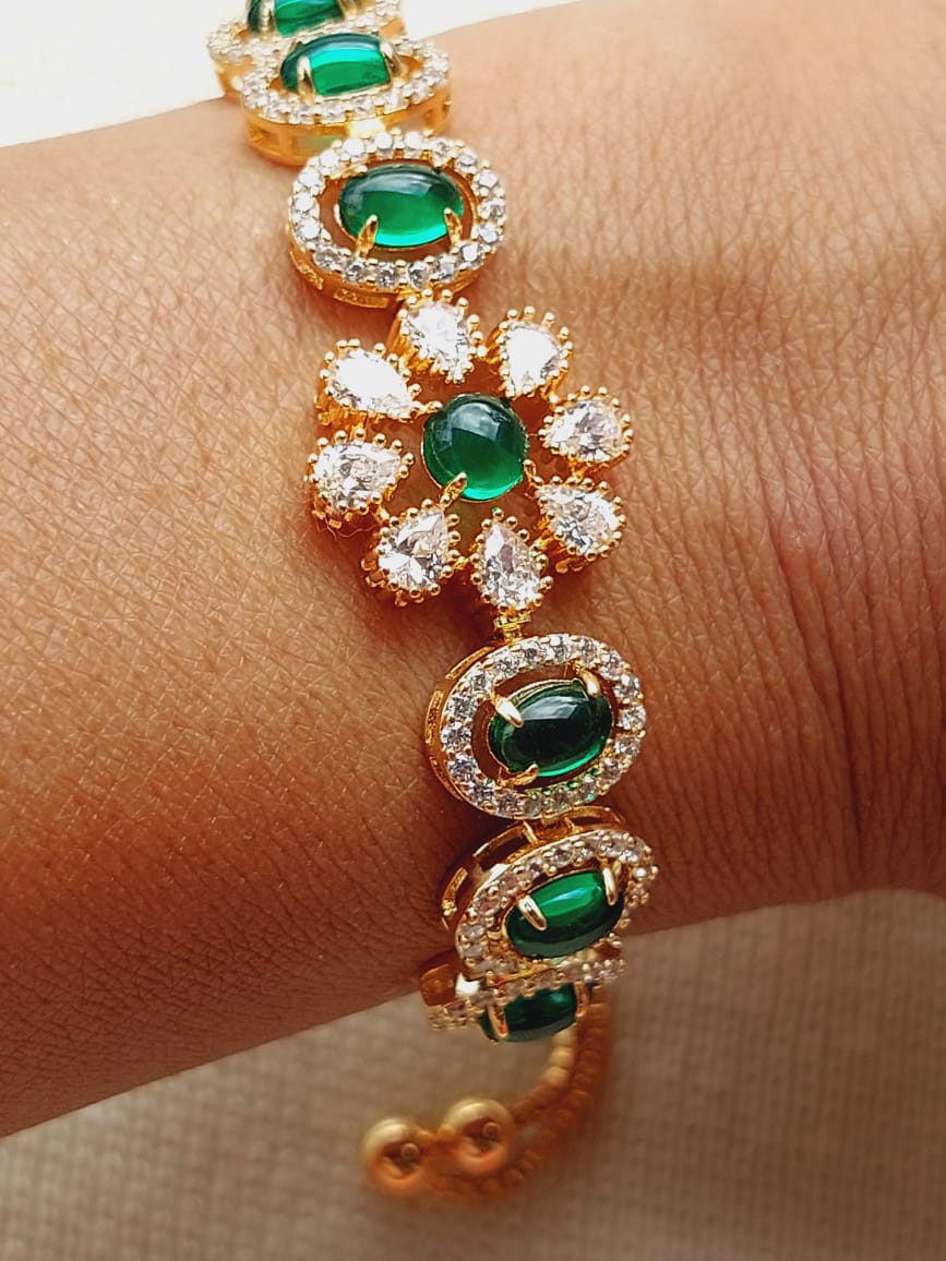 Elegant adjustable green pota mani American diamond bracelet from Mugdha Jewellery Store, featuring a floral design with sparkling stones.