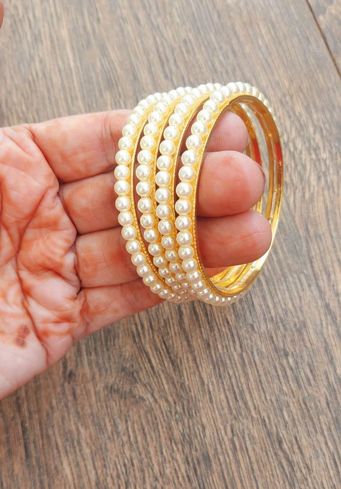 Simple Pearl Bangles for Size 2 by 6 from Mugdha Jewellery Store on wooden surface
