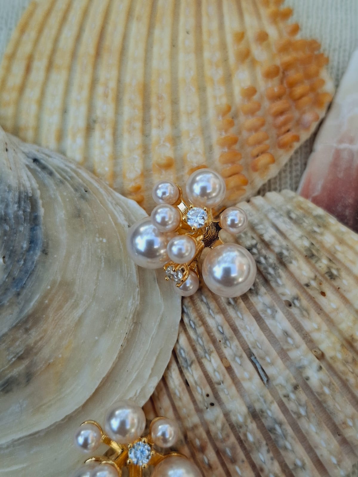 Swarovski pearl and American diamond earrings on natural seashell background