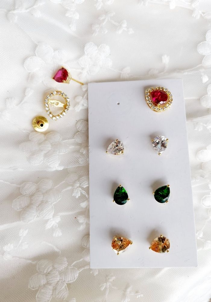 Elegant gold-toned leaf changeable earrings with interchangeable ruby, diamond, and emerald accents displayed on a white background