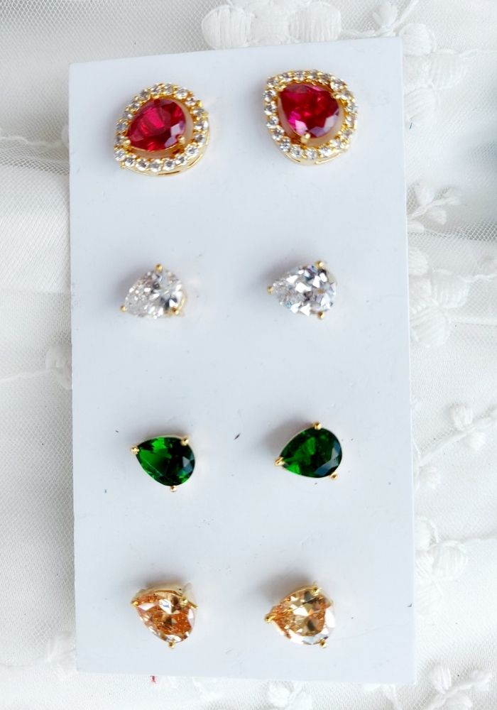 Elegant 4-in-1 changeable leaf-shaped earrings in gold-tone settings with sparkling ruby, emerald, and crystal gems from the Mugdha Jewellery Store.