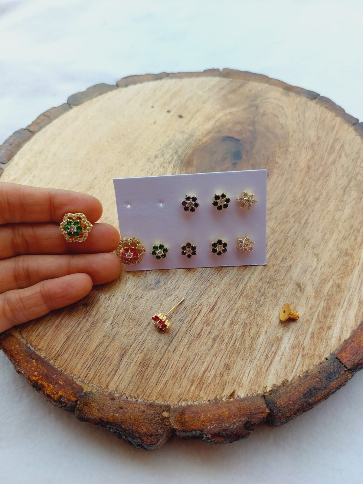 Elegant Flower Changeable Earrings on Wooden Surface