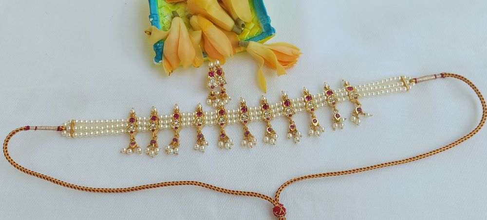 Stylish pink and white stone chinchpeti from Mugdha Jewellery Store, adorned with intricate gold-toned accents.