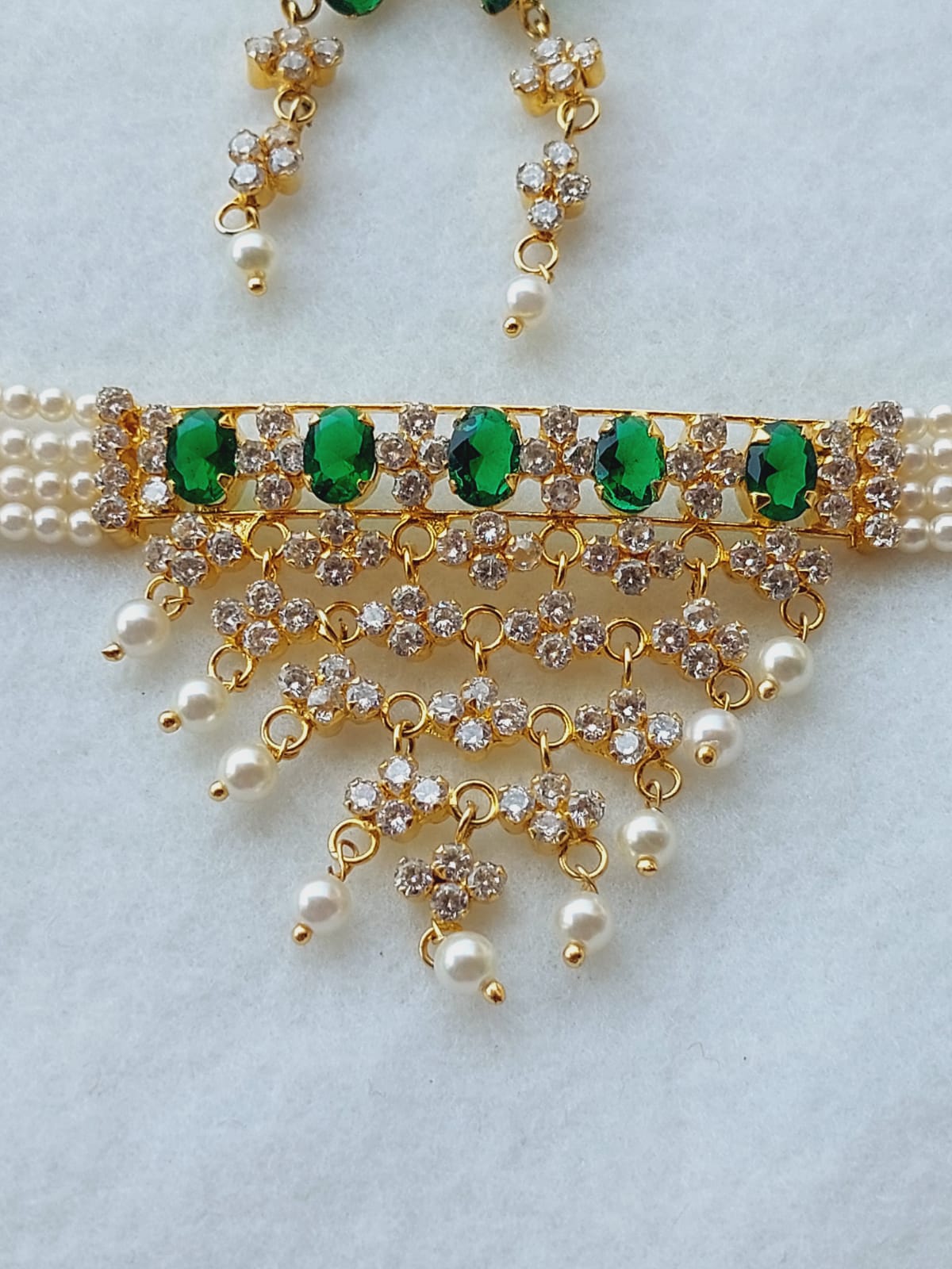 Elegant green and gold floral necklace with pearls and rhinestones from Mugdha Jewellery Store.
