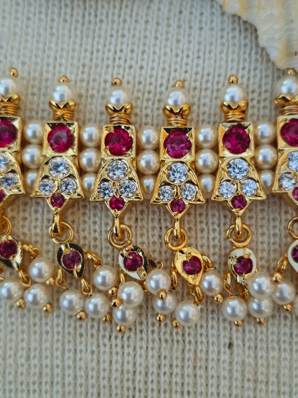 Elegant gold-plated 23 Patti 3 White Stone Rajwada Chinchpeti from Mugdha Jewellery Store, featuring sparkling ruby-colored stones and lustrous pearls.