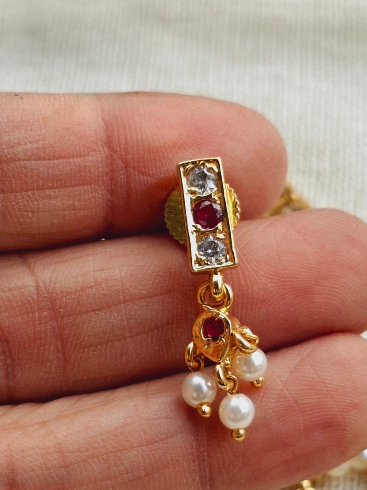 Elegant gold-tone pendant with sparkling crystals and pearls, showcasing the traditional Chinchpeti design from Mugdha Jewellery Store.