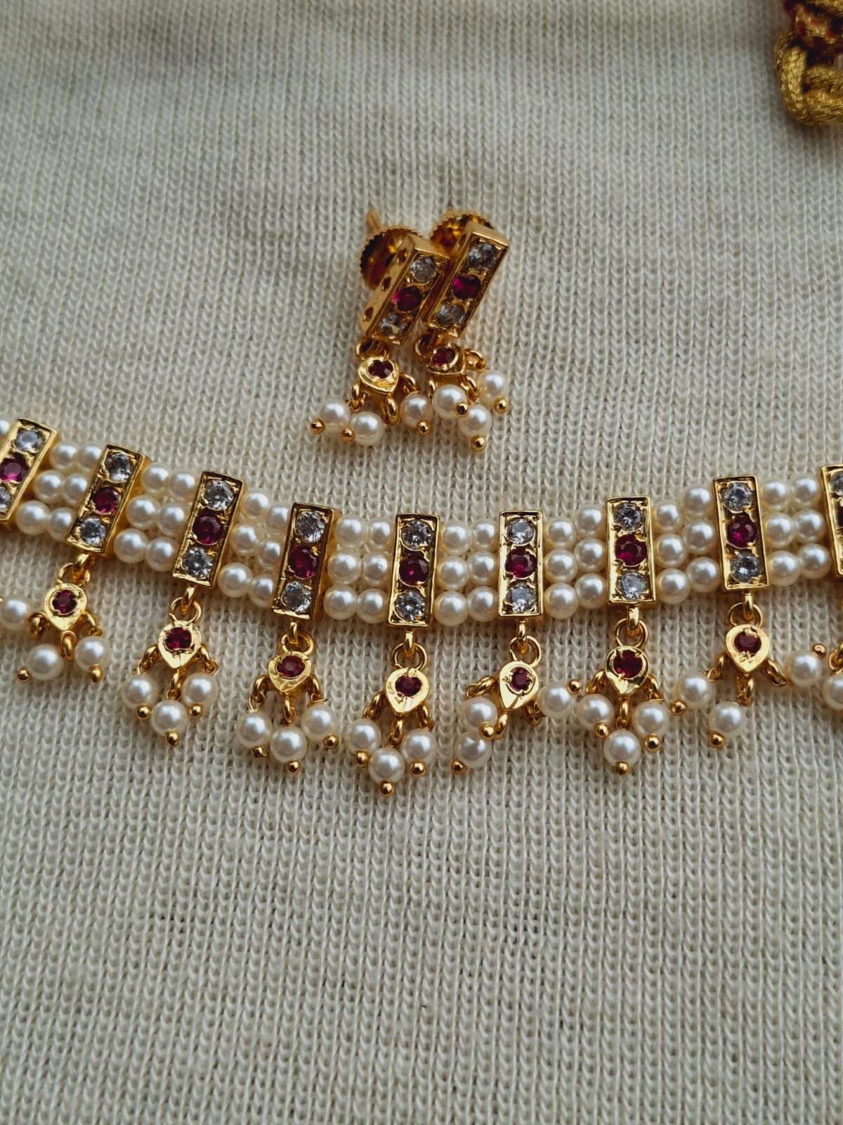 19 Patti Simple Traditional Chinchpeti from Mugdha Jewellery Store, featuring intricate gold-toned embellishments and lustrous pearls.