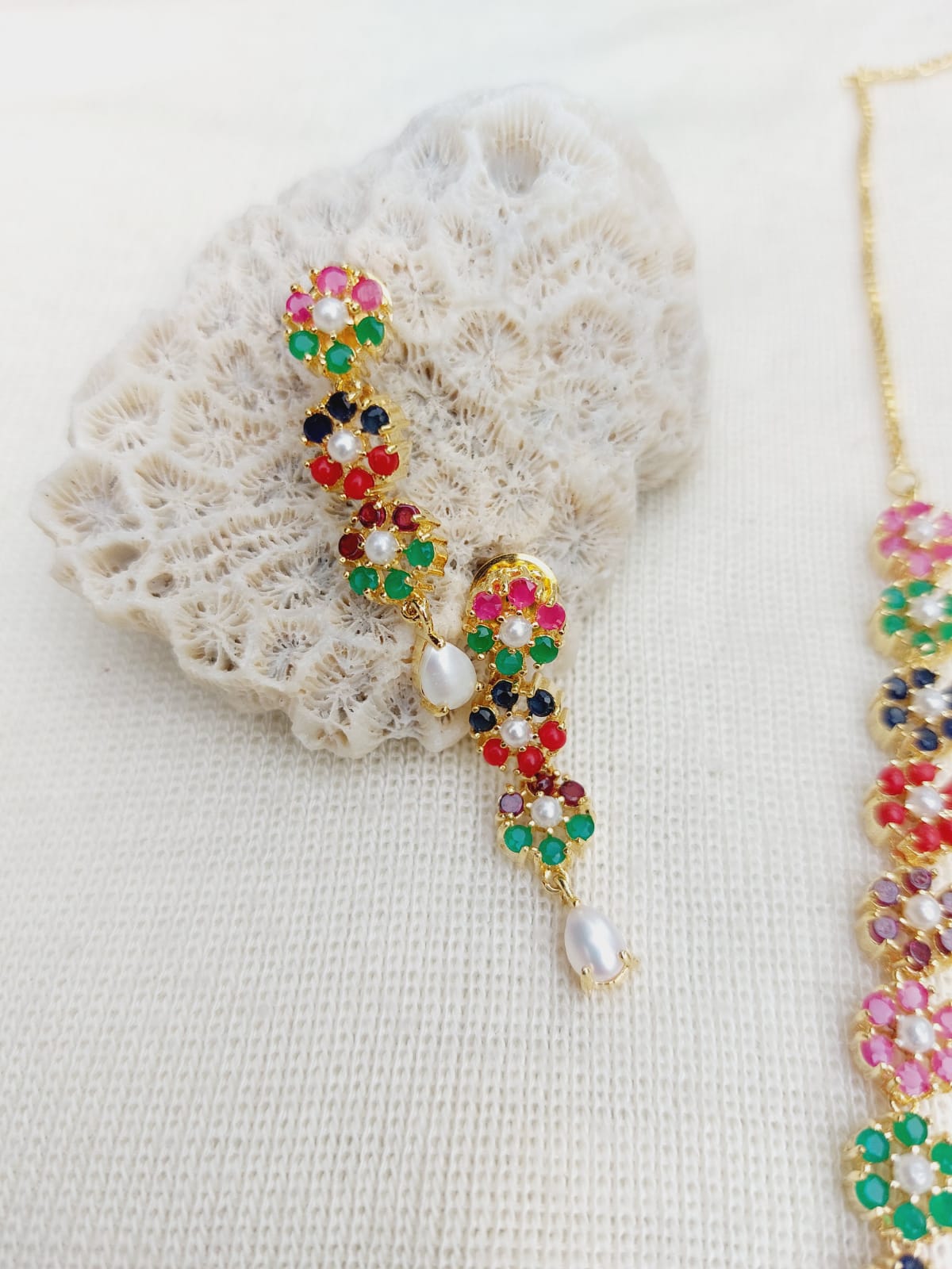 Colorful Navratna Flower Necklace on Delicate Lace Background