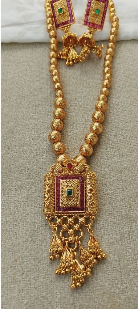 Square Pendant Short Designer Necklace from Mugdha Jewellery Store. Gold-tone beaded necklace with ornate red and green gemstone pendant.