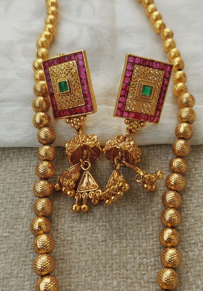 Square Pendant Short Designer Necklace from Mugdha Jewellery Store. Gold-toned beaded necklace with ruby and emerald accented square pendants.