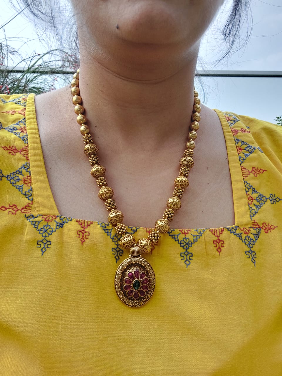 Lavanya Designer Beads Flower Pendant Necklace from Mugdha Jewellery Store
Gold-toned beaded necklace with ornate floral pendant showcasing intricate design