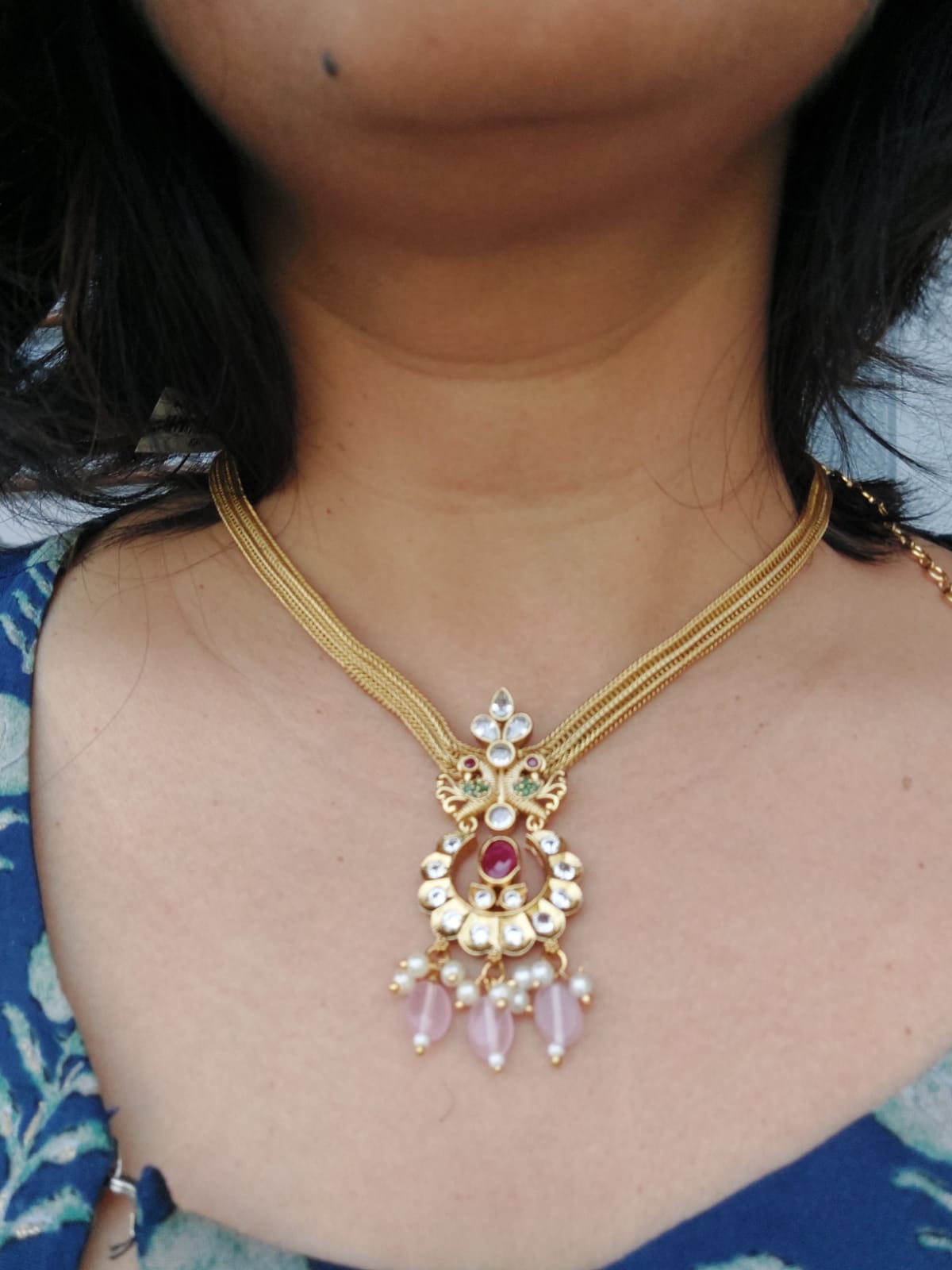 Elegant gold-toned necklace with intricate kundan and baby pink bead pendant