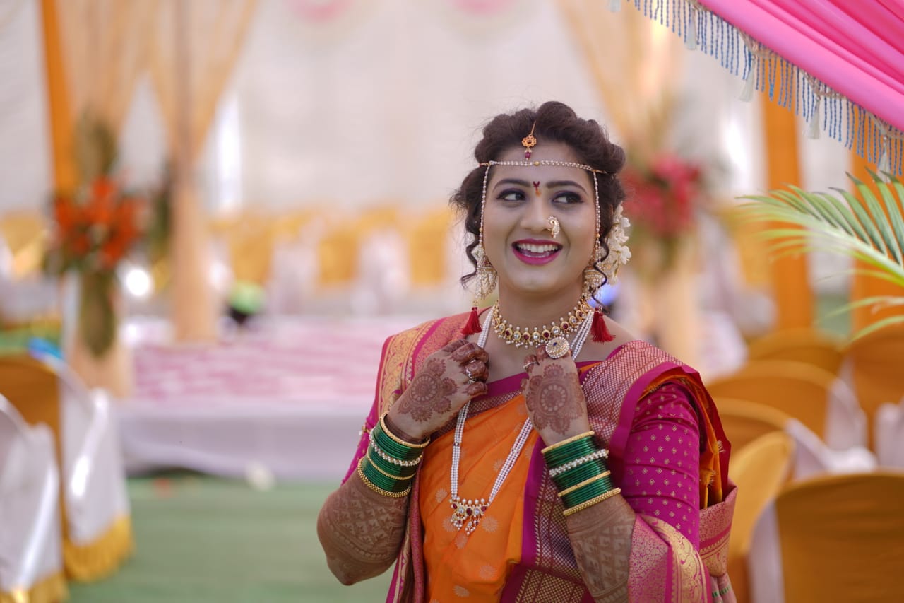 Elegant Indian bridal look with red, white, and green jewelry