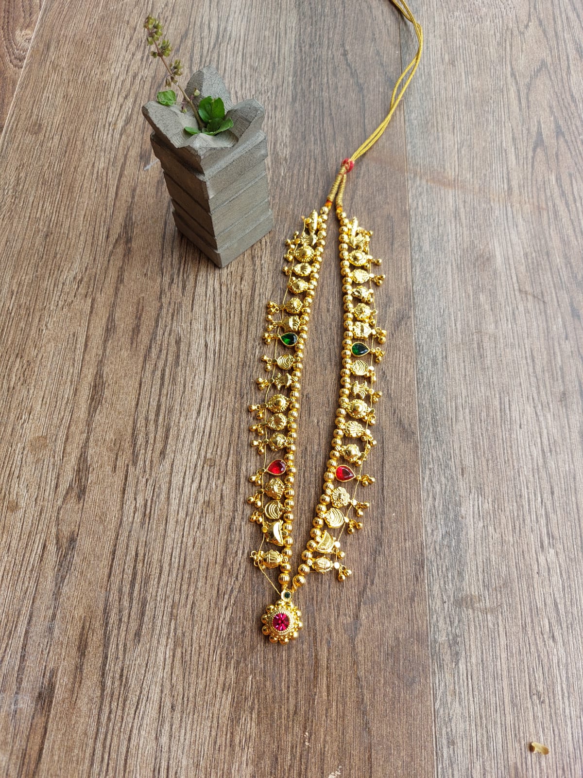 Multicolored Beaded Kolhapuri Saaj Necklace on Wooden Backdrop