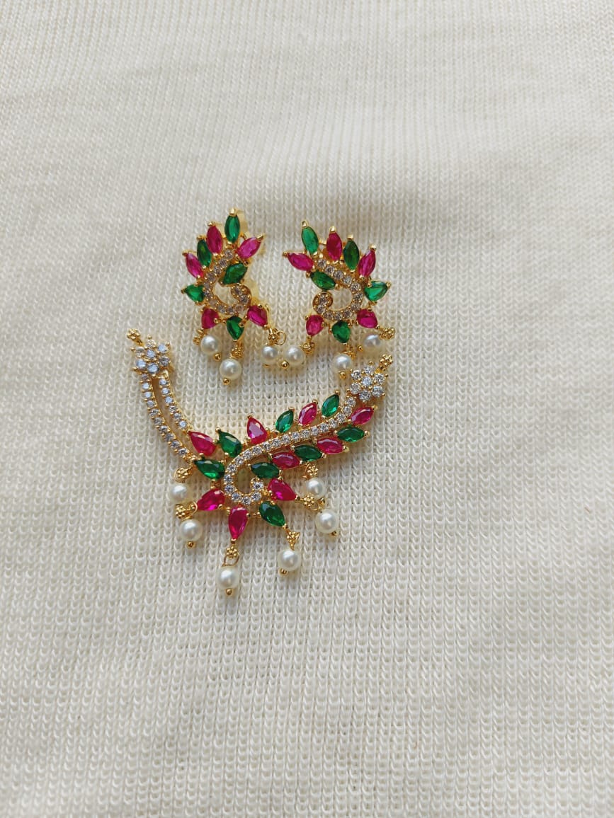 Colorful designer pendant mangalsutra with vibrant gemstones and pearl accents, displayed on a plain white background.