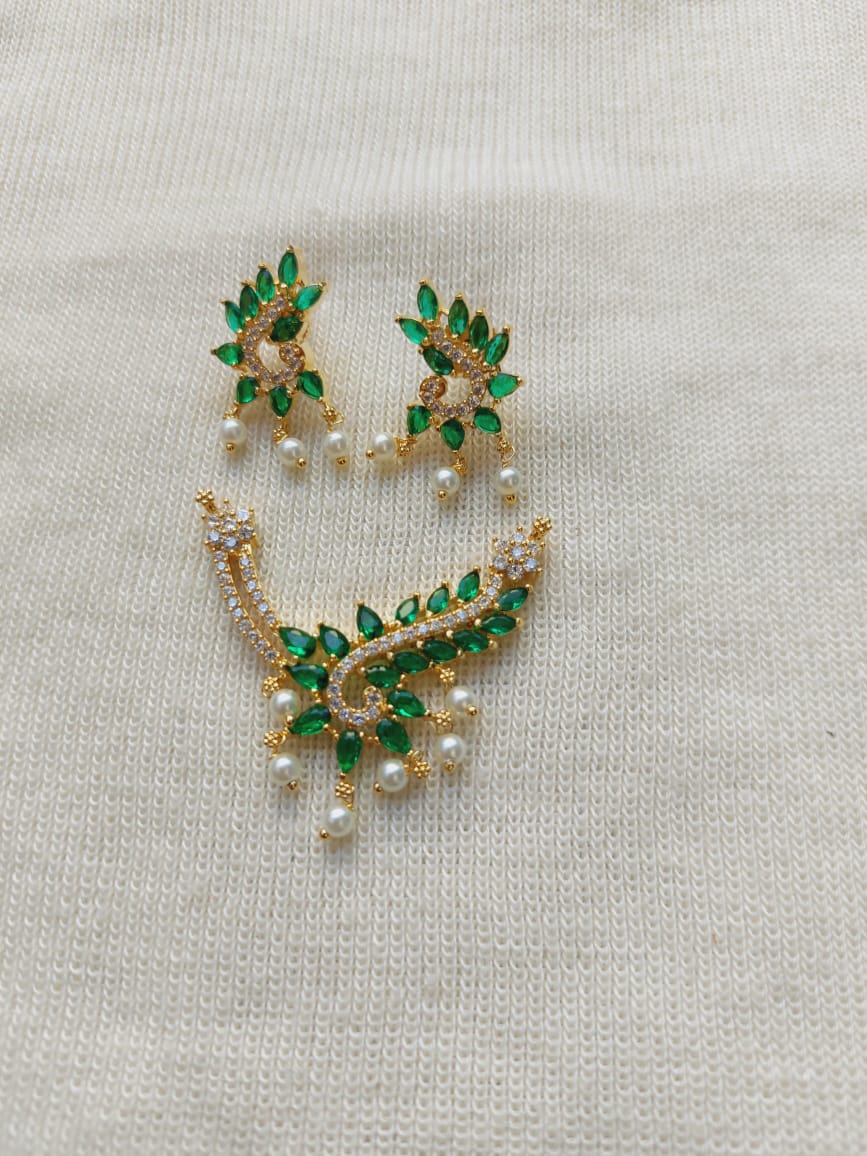 Elegant green and gold designer pendant mangalsutra with pearls, showcased on a plain white background.