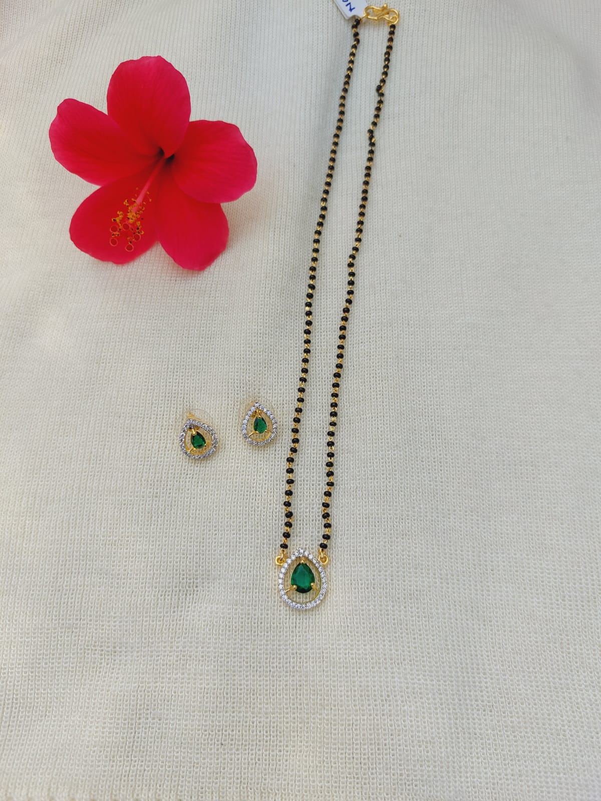 Green Stone Short Mangalsutra from Mugdha Jewellery Store