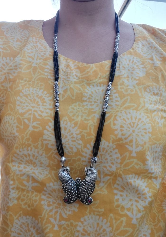 Elegant Oxidized Silver Peacock Pendant Mangalsutra with Beaded Tassels on Yellow Floral Blouse