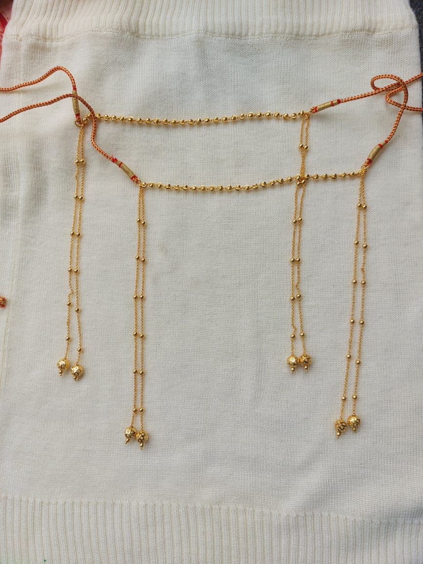 Delicate and Elegant Golden Mundavali - Ornate gold necklace with intricate beaded strands against a soft white fabric background.