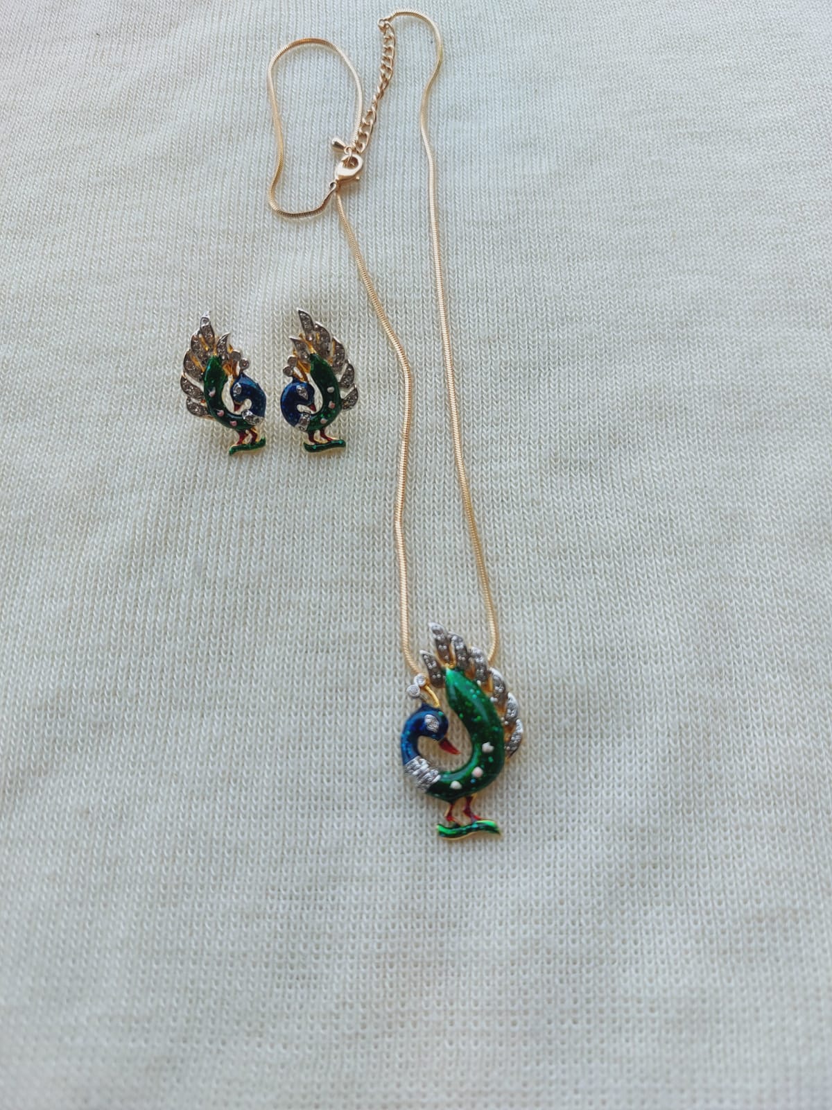 Meenawork Peacock Set with designer chain, featuring a colorful peacock pendant necklace and matching peacock earrings displayed on a plain background.