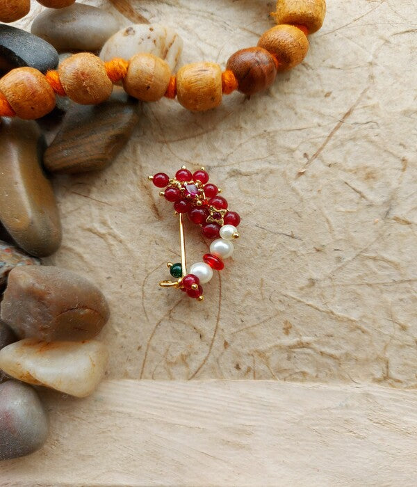 Small Traditional Red Nath with Red Stones on Wooden Surface