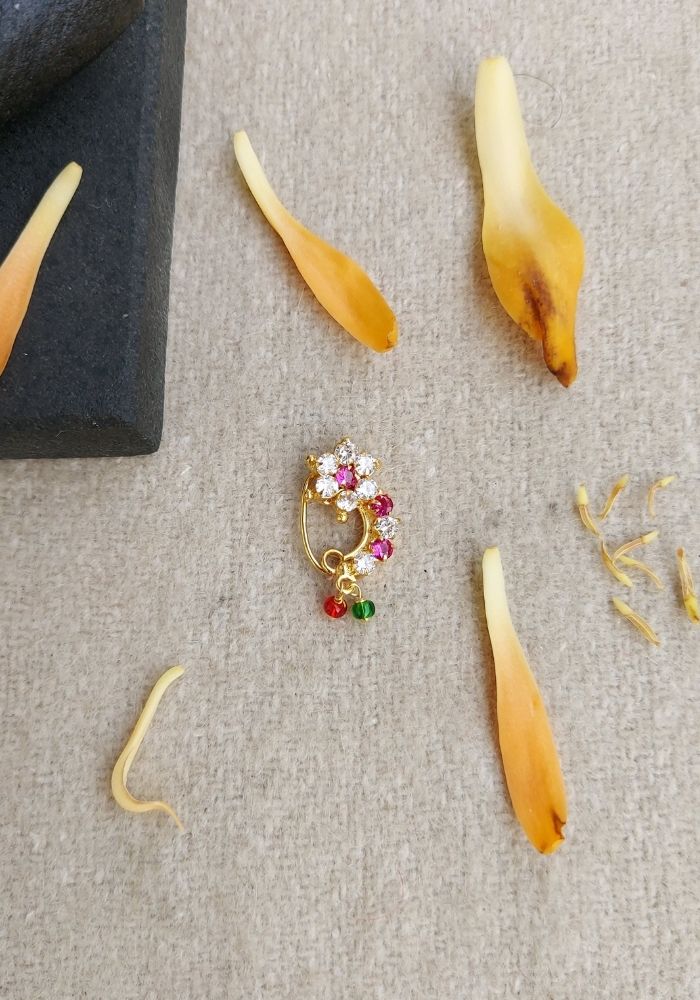 Small Elegant Floral Nath with Colored Stones on a Grey Background