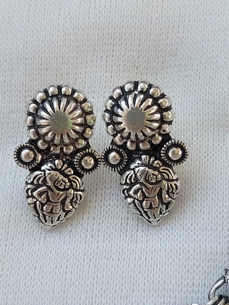 Ornate oxidized necklace set with floral and geometric patterns, decorative elements, and metallic accents displayed on a white background.