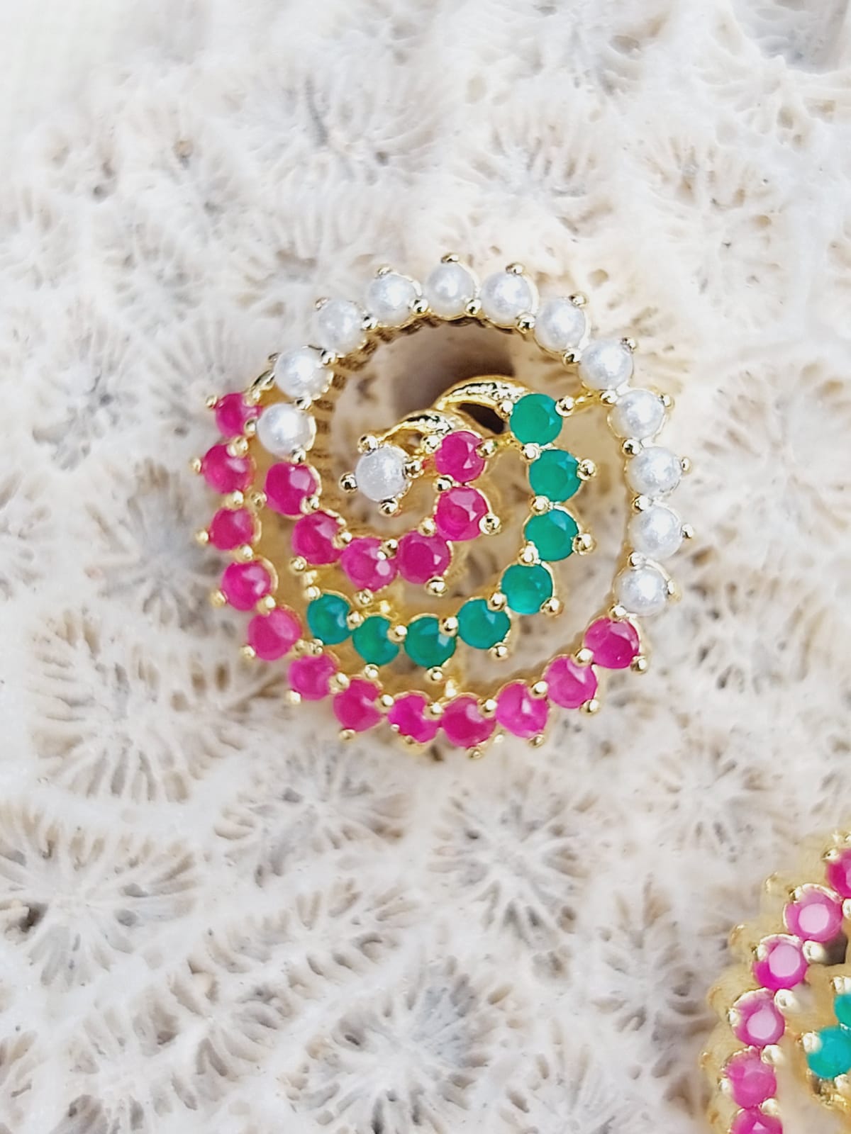 Elegant Navaratna Pendant Set: Sparkling gemstone-studded pendant on a plush, textured background