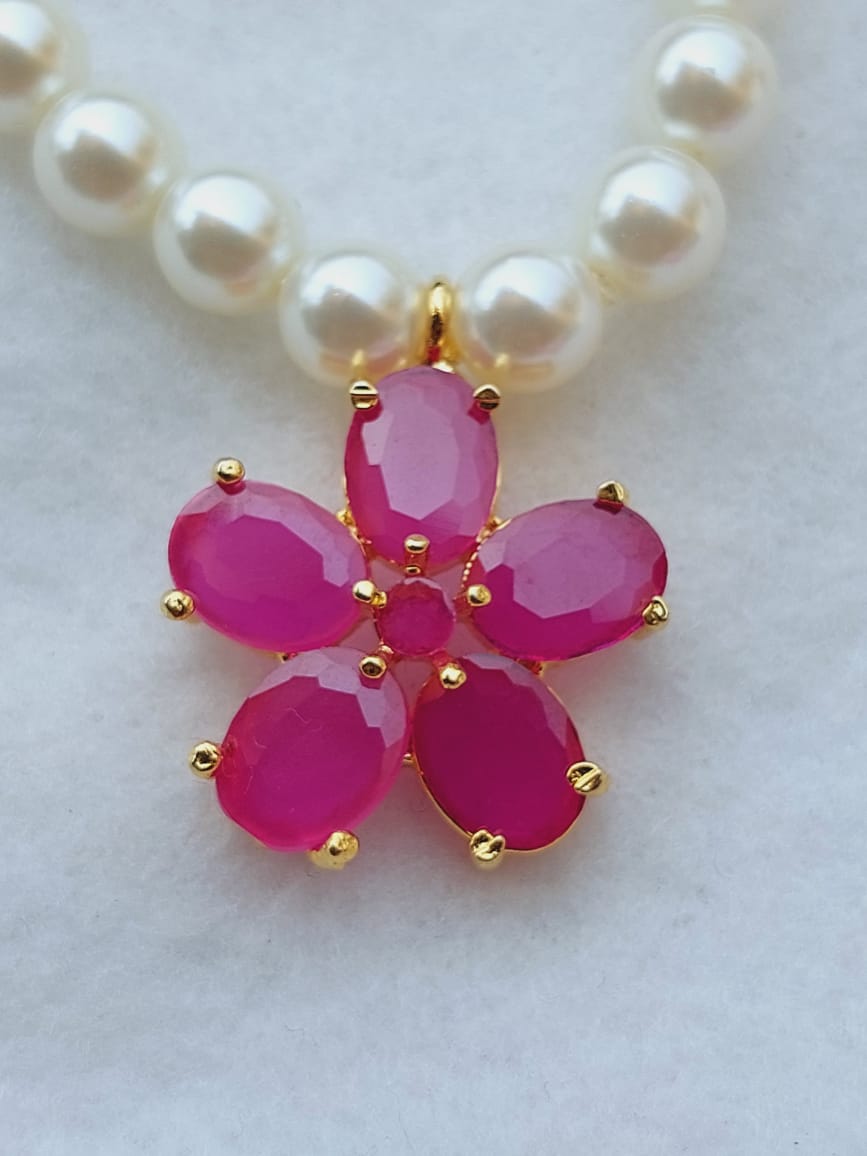 Elegant pearl necklace with vibrant pink flower pendant from Mugdha Jewellery Store