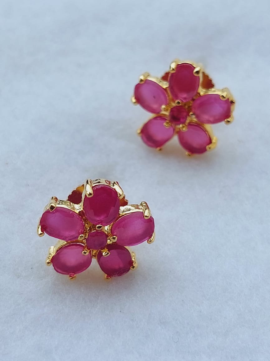 Elegant pink flower pearl earrings from Mugdha Jewellery Store, showcasing lush ruby-colored petals set in a gleaming gold-tone finish.