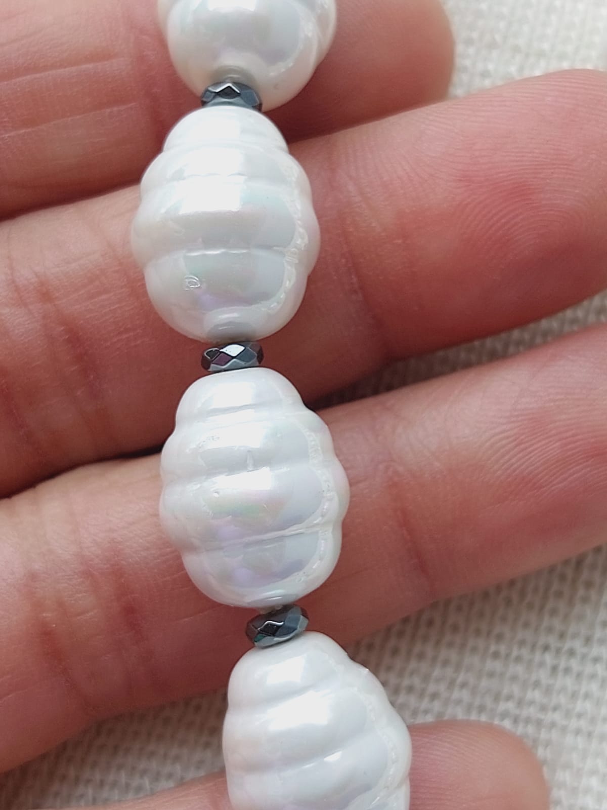 Elegant Freshwater Pearl Set
Lustrous white pearls with silver accents displayed on hand