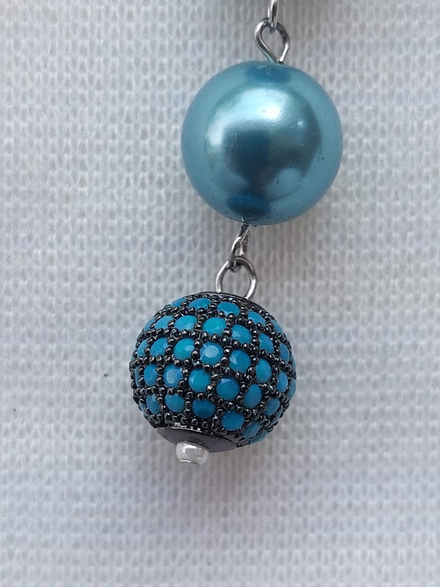 Elegant designer pearl necklace set with teal blue beads and a crystal-encrusted pendant