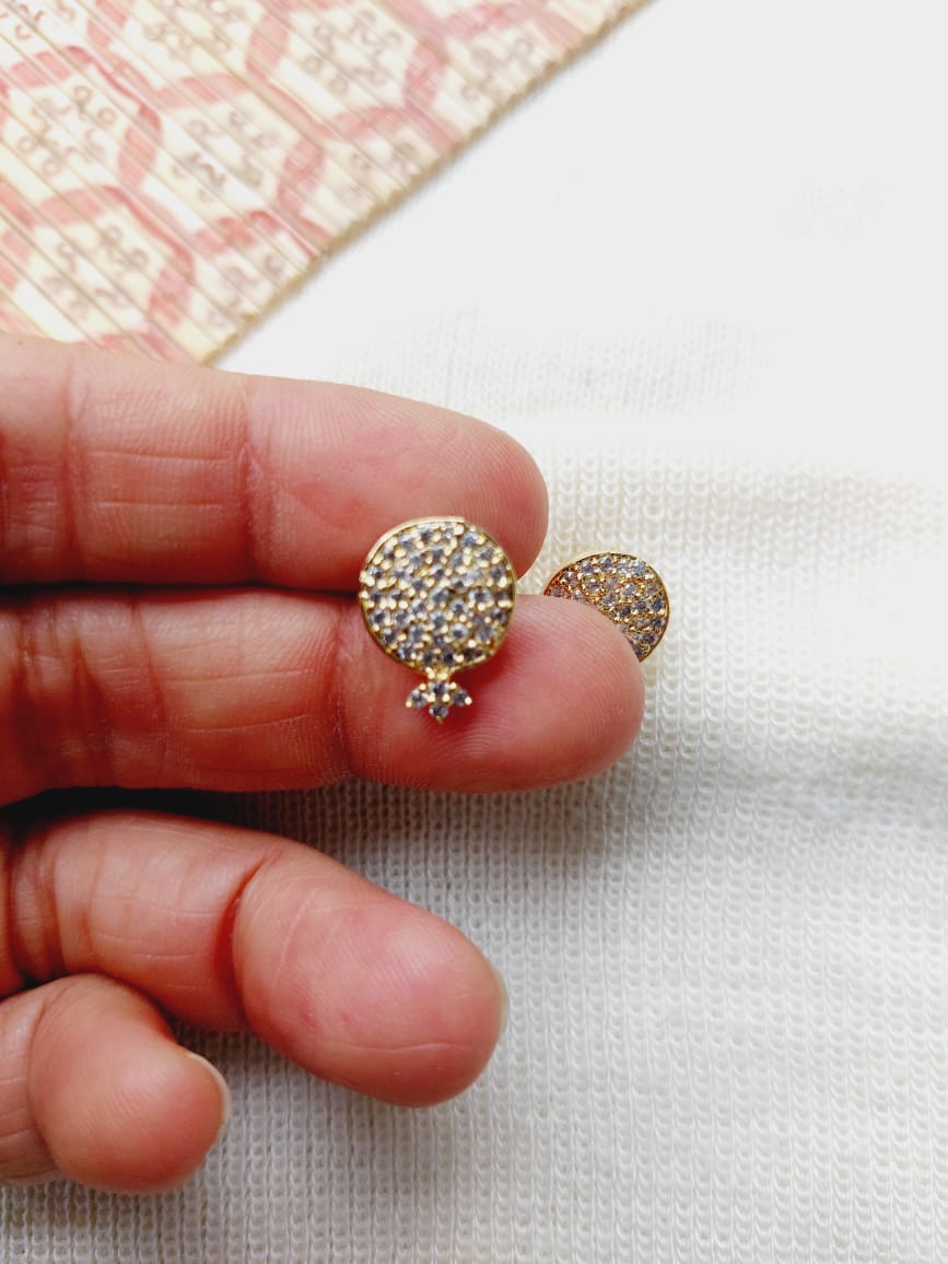 Elegant crystal-embellished round earrings displayed on a textured fabric background