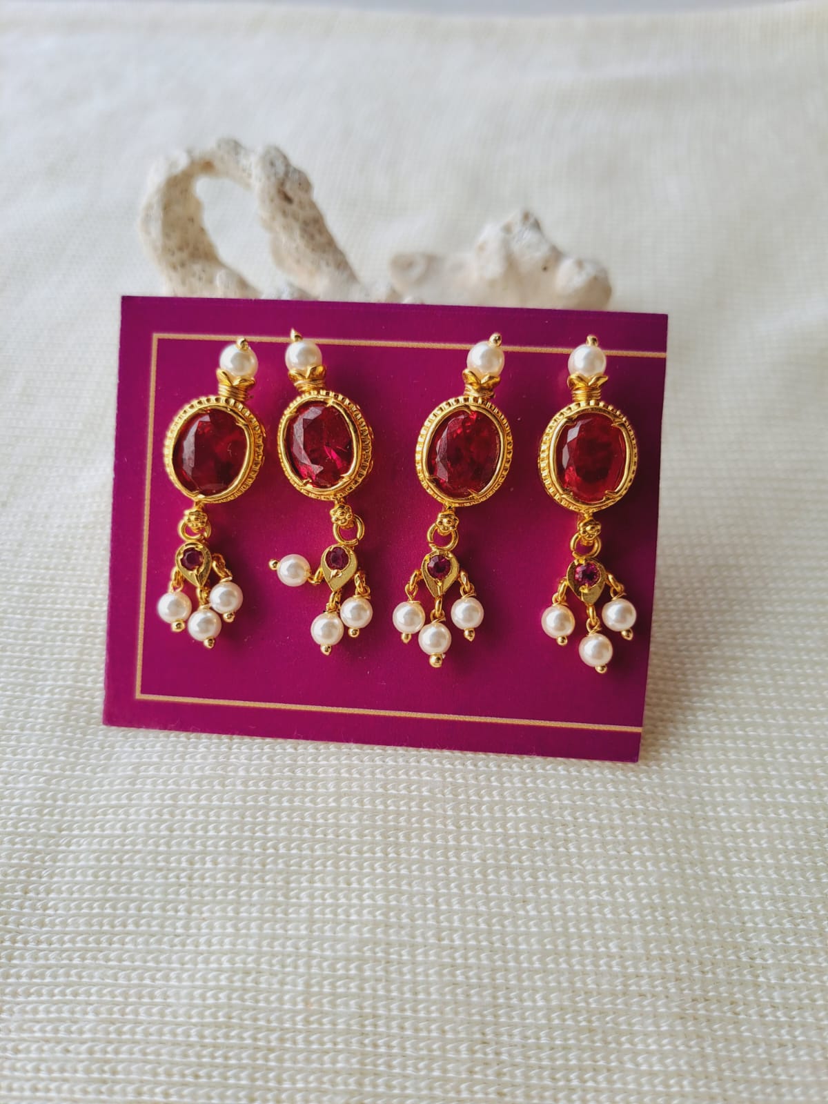Dark Pink Stone Danglers on display against a light background