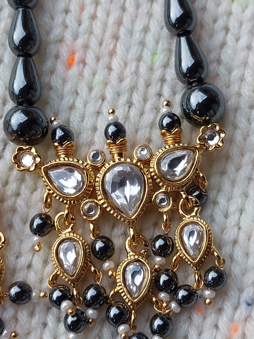 Premium Tanmani Collection - White Tanmani with Grey Beads
Ornate gold-toned jewelry piece with intricate bead and crystal detailing on a neutral background from the Mugdha Jewellery Store.