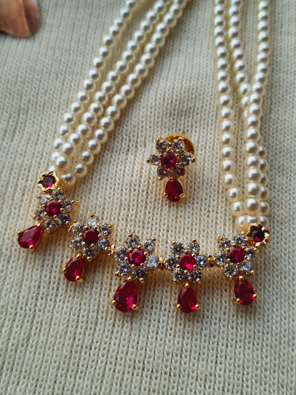 Simple and Cute Dark Pink and White Flower Tanmani Necklace with Ruby Accents on Beige Knitted Backdrop