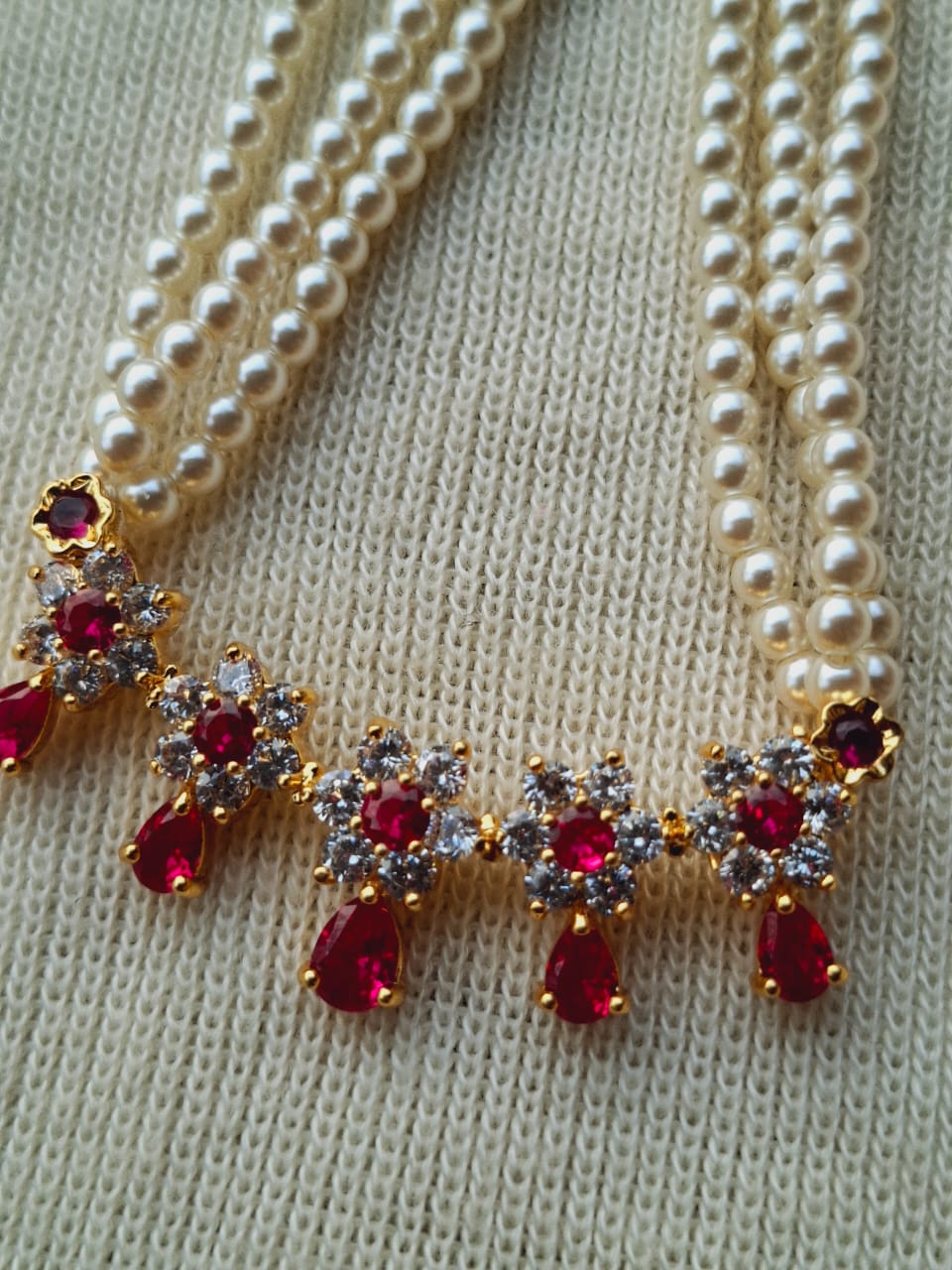 Simple and elegant pearl necklace with a vibrant, jewel-encrusted pendant in the Mugdha Jewellery Store collection.