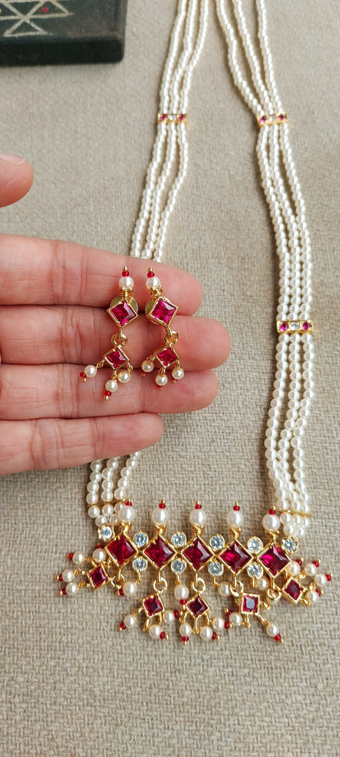 Elegant pearl and ruby necklace with intricate pendant design from Mugdha Jewellery Store