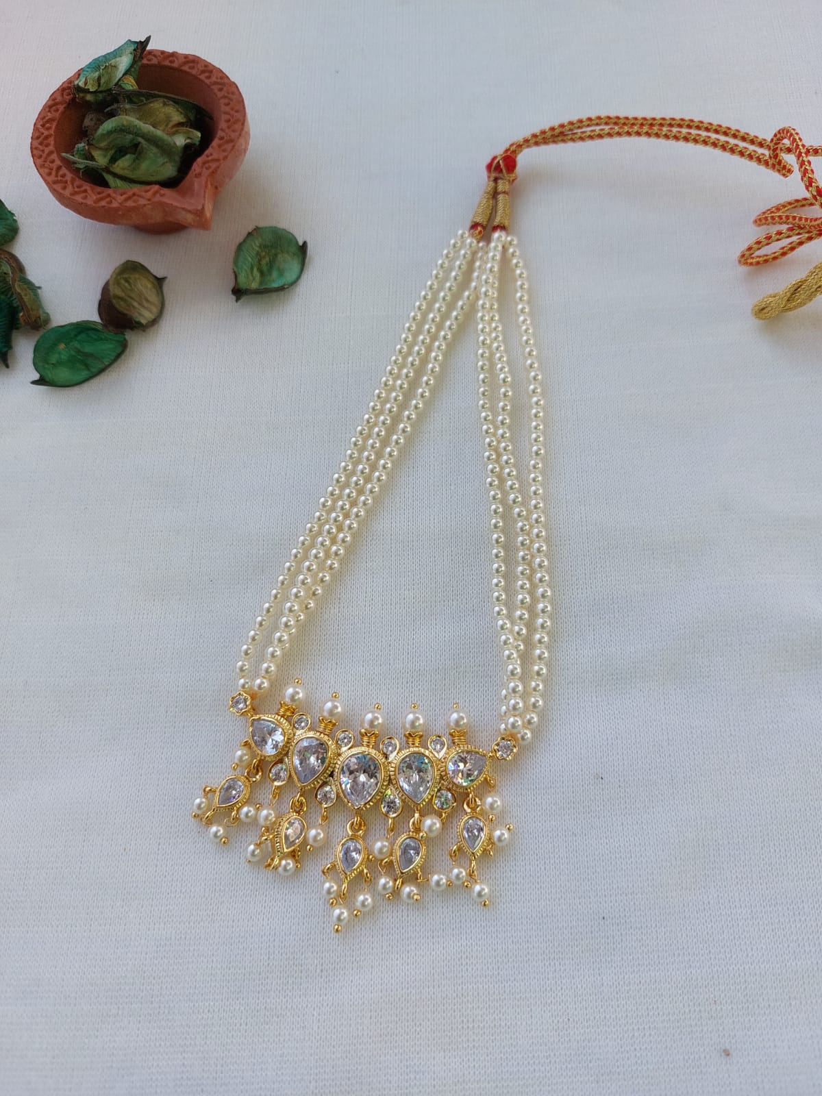 Elegant Pearl and Gold Puneri Tanmani Necklace - Exquisite multi-strand pearl necklace with sparkling gold accents, showcased on a white background.