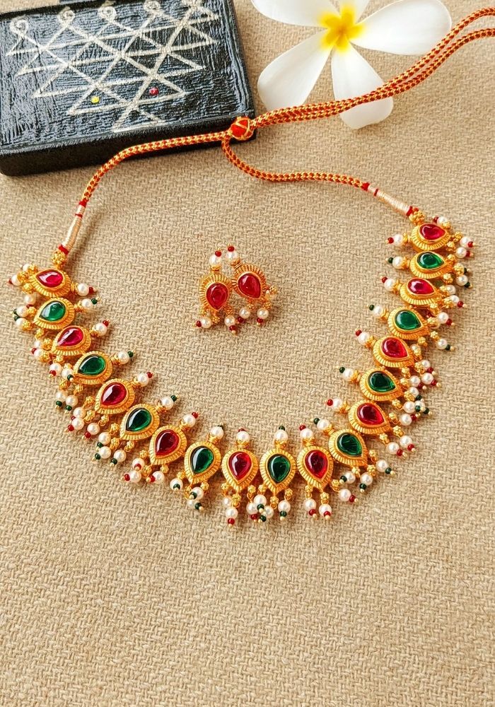 Colorful stone-studded gold necklace and earrings set from Mugdha Jewellery Store