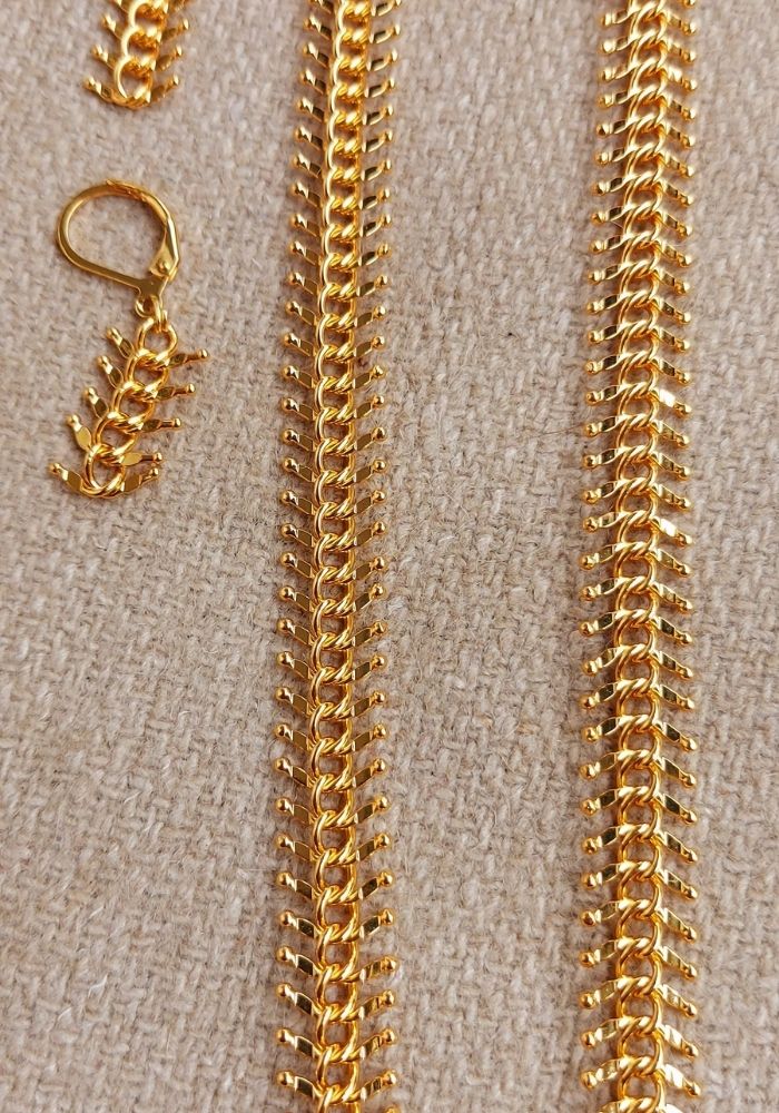 Traditional Durva Haar 30 Inch Necklace
A close-up view of a traditional Indian necklace with a golden chain displaying a delicate, intricately designed chain pattern.