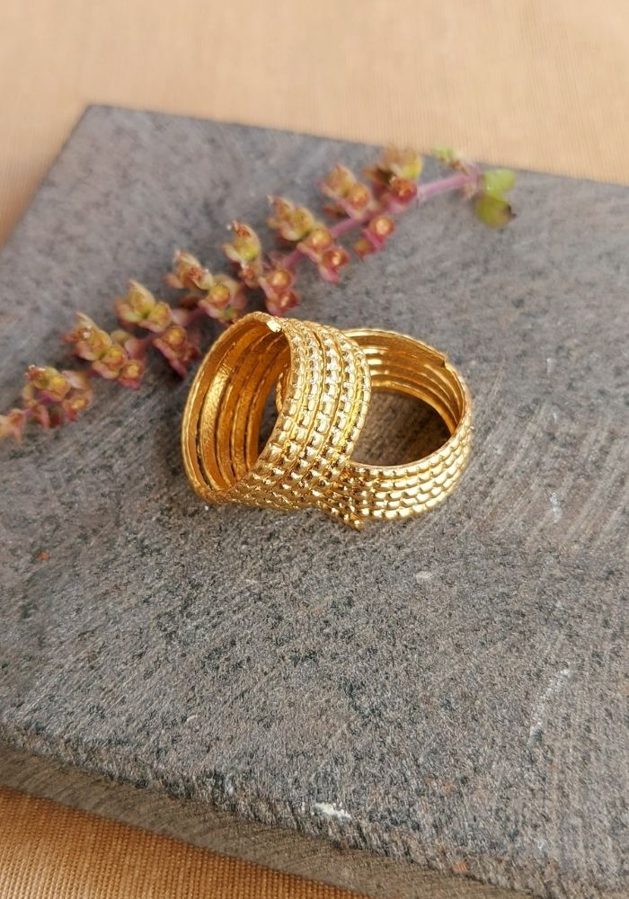 Traditional Five Layer Gold Toe Ring on Grey Cloth
